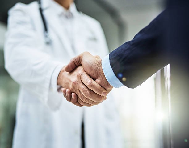 Doctor shaking hands with patient — trusted health partner
